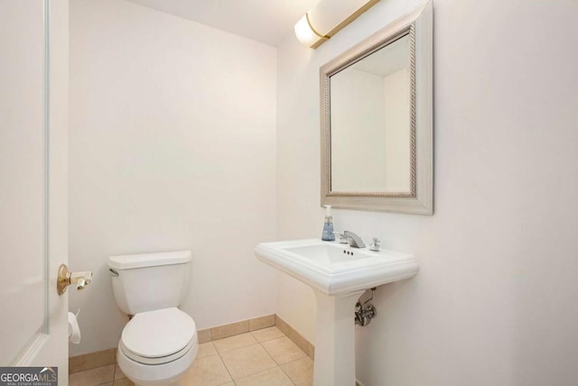 195 14th St NE Ph 306, Atlanta, GA 30309 - bathroom with baseboards, toilet, and tile patterned floors