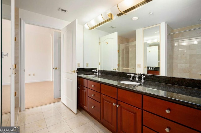195 14th St NE Ph 306, Atlanta, GA 30309 - bathroom with a tile shower, tile patterned floors, and double vanity