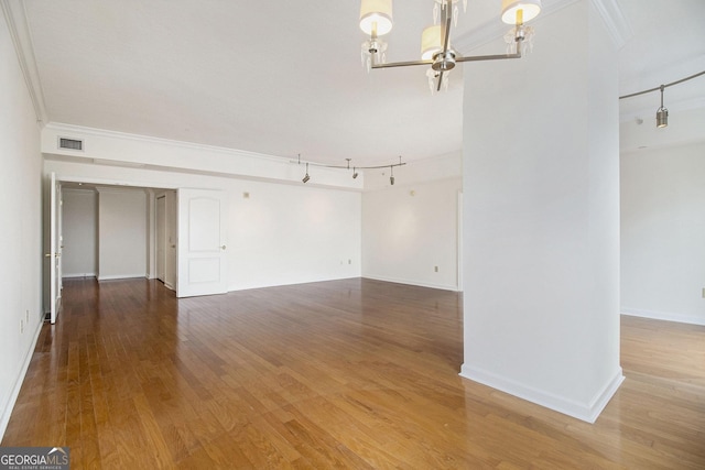 195 14th St NE Ph 306, Atlanta, GA 30309 - unfurnished room featuring a chandelier, crown molding, wood finished floors, and baseboards
