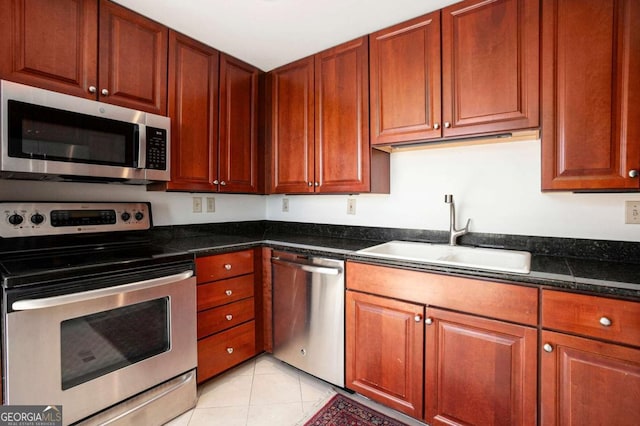 195 14th St NE Ph 306, Atlanta, GA 30309 - kitchen featuring appliances with stainless steel finishes, a sink, dark countertops, and light tile patterned floors