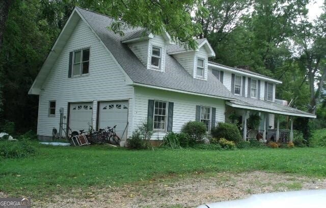 78 Ramblin Rose Ln, Rabun Gap, GA 30568 - view of front of house featuring an attached garage, a front yard, and roof with shingles