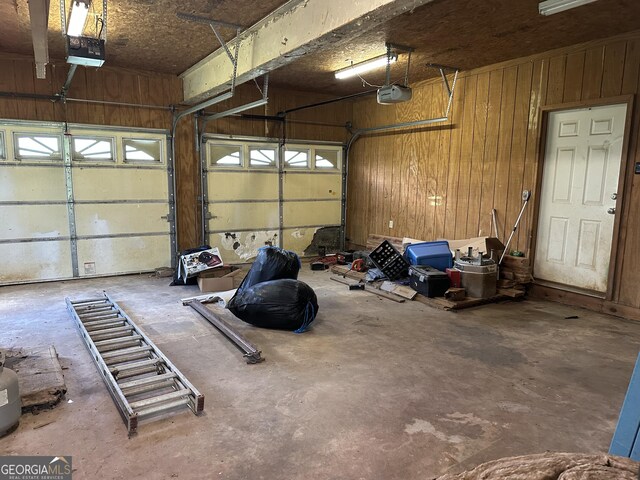 78 Ramblin Rose Ln, Rabun Gap, GA 30568 - garage with a garage door opener and wooden walls