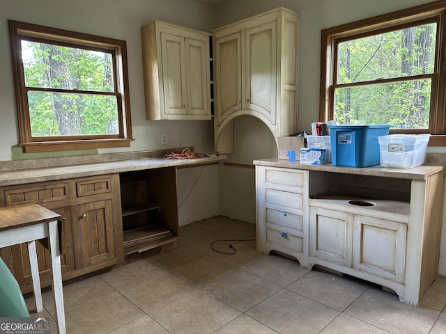 78 Ramblin Rose Ln, Rabun Gap, GA 30568 - kitchen featuring light tile patterned flooring, light countertops, and cream cabinets