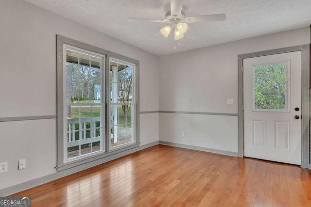 2285 Bascomb Carmel Rd, Woodstock, GA 30189 - unfurnished room featuring ceiling fan, light wood-style floors, and a textured ceiling