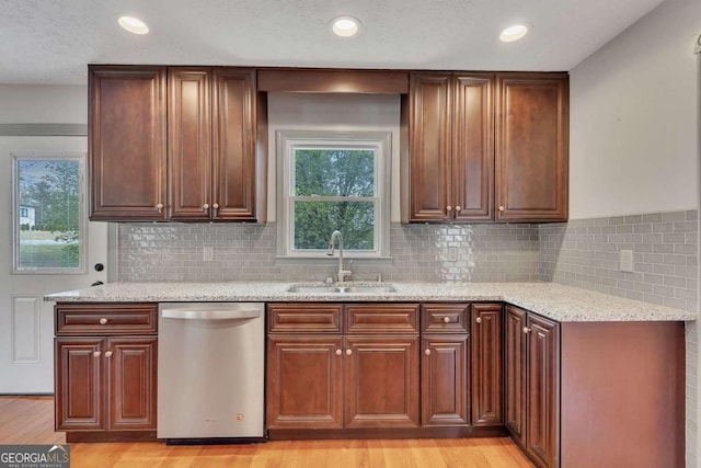 2285 Bascomb Carmel Rd, Woodstock, GA 30189 - kitchen with dishwasher, light stone countertops, light wood-style flooring, decorative backsplash, and recessed lighting