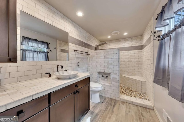 2285 Bascomb Carmel Rd, Woodstock, GA 30189 - bathroom with vanity, a walk in shower, wood finished floors, tasteful backsplash, and recessed lighting