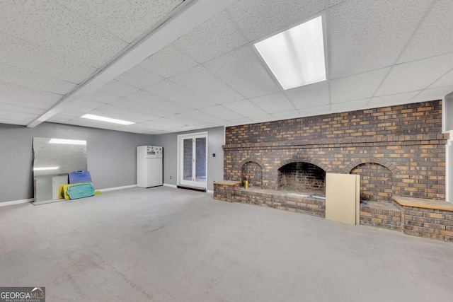 2285 Bascomb Carmel Rd, Woodstock, GA 30189 - below grade area featuring a brick fireplace, a drop ceiling, and brick wall