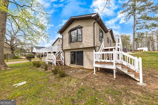2285 Bascomb Carmel Rd, Woodstock, GA 30189 - back of house with stairway, a deck, stucco siding, and a yard