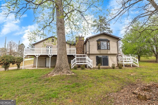 2285 Bascomb Carmel Rd, Woodstock, GA 30189 - rear view of house featuring stairway, a deck, stucco siding, and a yard