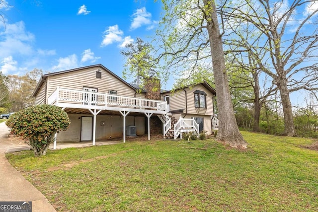 2285 Bascomb Carmel Rd, Woodstock, GA 30189 - rear view of property with a wooden deck, a lawn, stairs, and a chimney