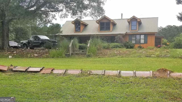 log-style house featuring fence, covered porch, a front yard, log siding, and metal roof