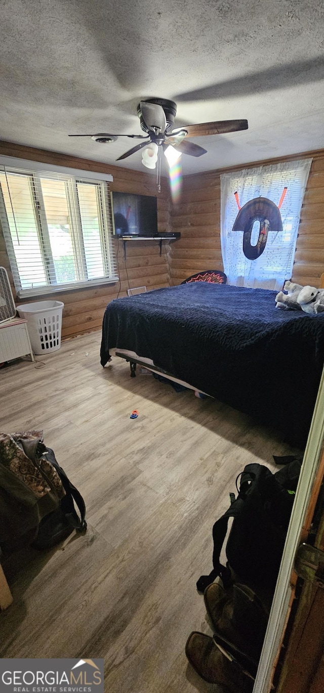 bathroom featuring vanity, log walls, tile patterned flooring, and toilet