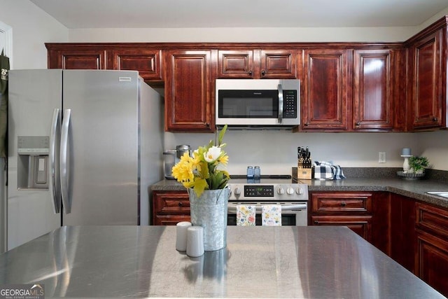 413 W I Pkwy, Dallas, GA 30132 - kitchen with dark countertops, dark brown cabinets, and appliances with stainless steel finishes