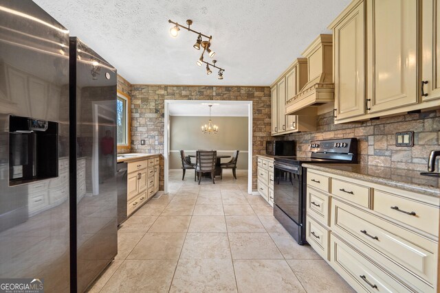 carpeted bedroom featuring a textured ceiling, ensuite bathroom, baseboards, and a ceiling fan