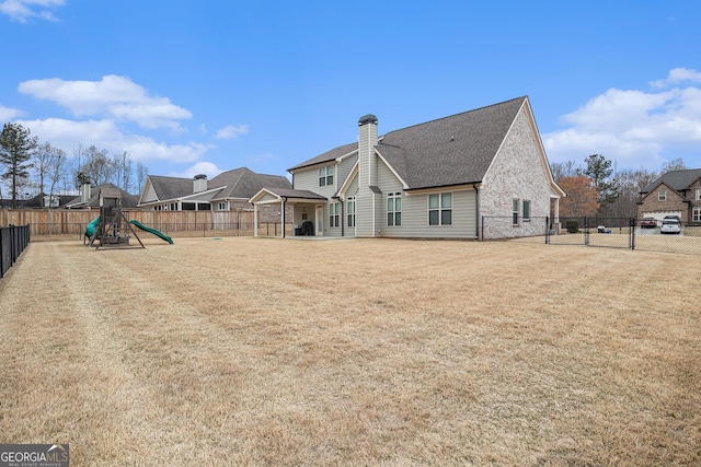 2129 Apalachee Trl, Monroe, GA 30656 - rear view of property featuring a playground, a chimney, and a shingled roof
