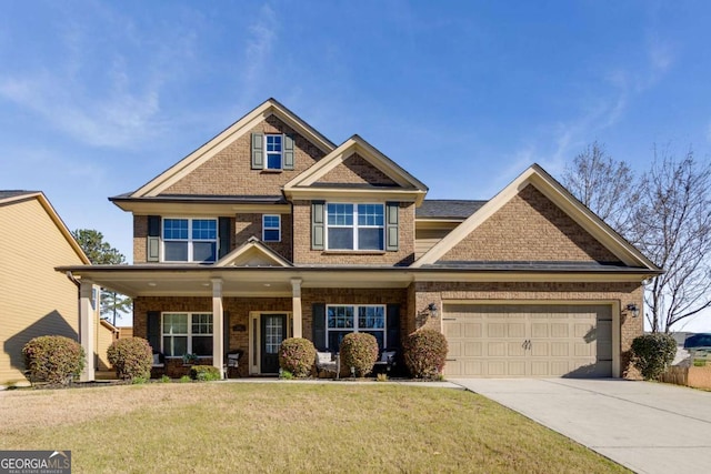 3475 Summerlin Pkwy, Lithia Springs, GA 30122 - craftsman-style house with a garage, concrete driveway, brick siding, a front lawn, and a porch