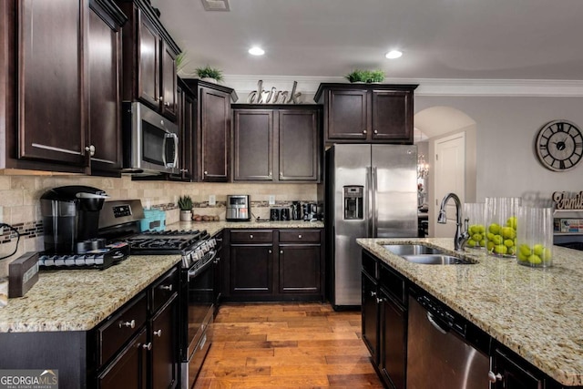 3475 Summerlin Pkwy, Lithia Springs, GA 30122 - kitchen with a sink, ornamental molding, appliances with stainless steel finishes, and decorative backsplash