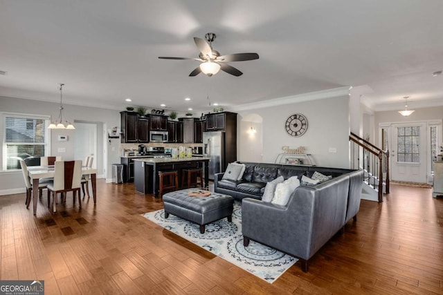 3475 Summerlin Pkwy, Lithia Springs, GA 30122 - living room featuring stairs, crown molding, ceiling fan, recessed lighting, and dark wood-style flooring