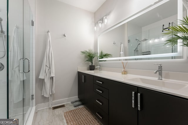 bathroom with a sink and a stall shower