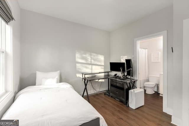 bedroom featuring baseboards and dark wood-style floors
