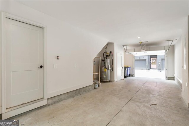 garage featuring water heater and baseboards