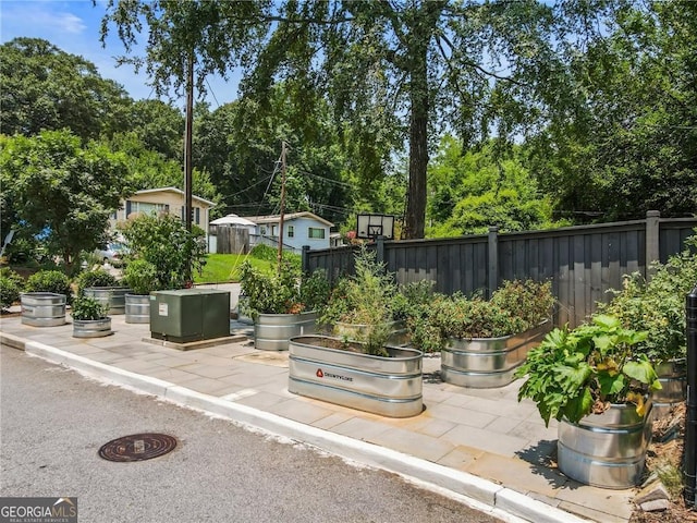 view of patio / terrace with a vegetable garden and fence