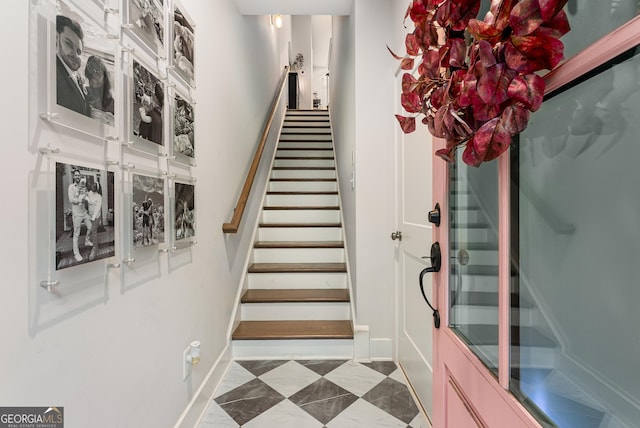 staircase featuring baseboards