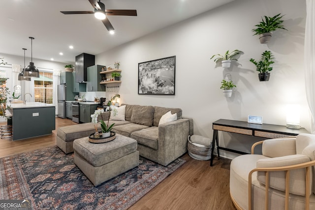 living room with recessed lighting, light wood-style floors, and ceiling fan