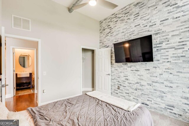 3820 Roswell Rd NE Unit 902, Atlanta, GA 30342 - bedroom featuring a closet, wood finished floors, baseboards, visible vents, and ceiling fan