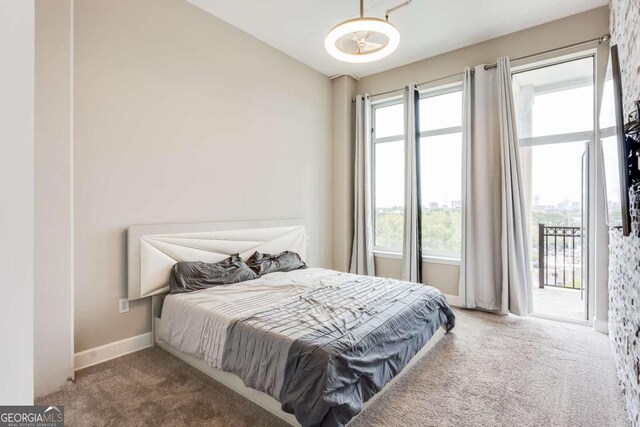 3820 Roswell Rd NE Unit 902, Atlanta, GA 30342 - carpeted bedroom with baseboards and access to outside