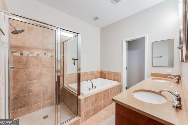 3820 Roswell Rd NE Unit 902, Atlanta, GA 30342 - bathroom featuring double vanity, a sink, a stall shower, and a garden tub