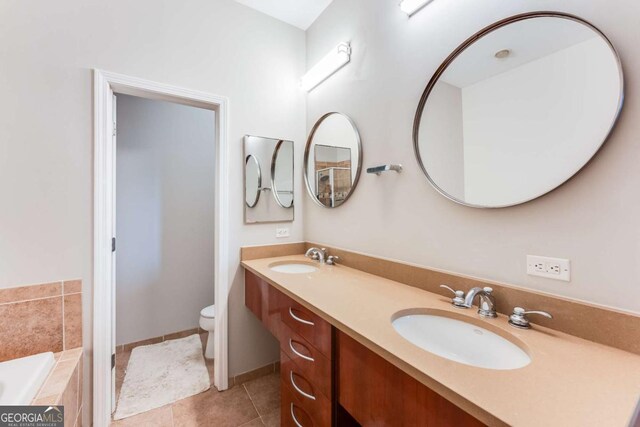 3820 Roswell Rd NE Unit 902, Atlanta, GA 30342 - full bathroom featuring double vanity, toilet, tile patterned flooring, and a sink
