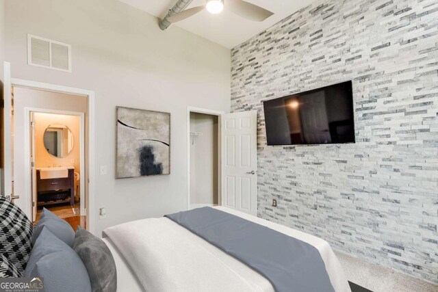 3820 Roswell Rd NE Unit 902, Atlanta, GA 30342 - bedroom featuring a closet, visible vents, an accent wall, and a ceiling fan