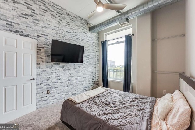 3820 Roswell Rd NE Unit 902, Atlanta, GA 30342 - bedroom featuring a ceiling fan, carpet, and an accent wall