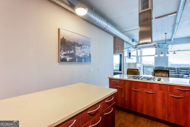 3820 Roswell Rd NE Unit 902, Atlanta, GA 30342 - kitchen featuring light countertops, visible vents, stainless steel gas cooktop, dark wood-type flooring, and island range hood