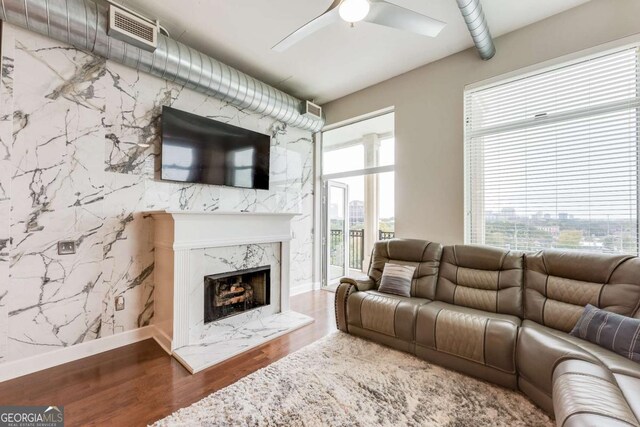 3820 Roswell Rd NE Unit 902, Atlanta, GA 30342 - living room featuring visible vents, a healthy amount of sunlight, a ceiling fan, and wood finished floors