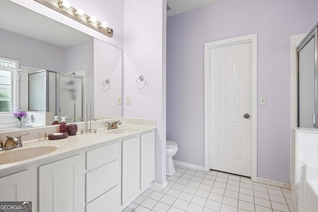 810 Abbotts Mill Ct Unit 83, Duluth, GA 30097 - bathroom with toilet, a sink, a stall shower, and tile patterned floors