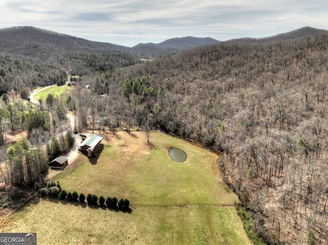drone / aerial view with a forest view and a mountain view
