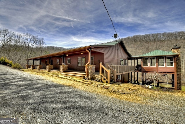 view of property exterior featuring a deck and a chimney