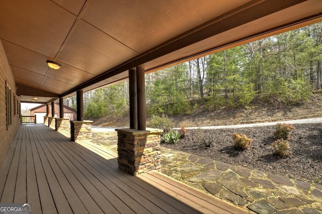 wooden terrace featuring an outbuilding