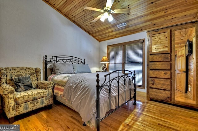 bedroom featuring vaulted ceiling, visible vents, ceiling fan, light wood finished floors, and wood ceiling