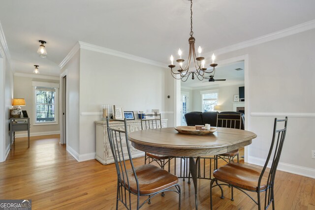 235 Chicopee Dr NE, Marietta, GA 30060 - dining area with a chandelier, crown molding, light wood-style floors, and baseboards