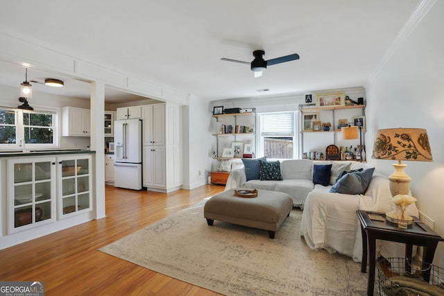 235 Chicopee Dr NE, Marietta, GA 30060 - living area with light wood finished floors, a ceiling fan, and crown molding