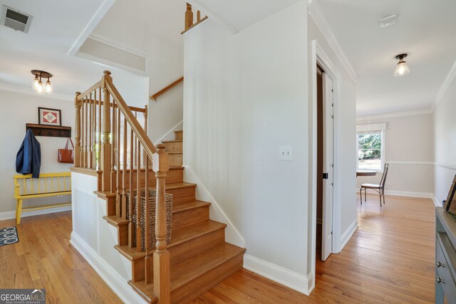 235 Chicopee Dr NE, Marietta, GA 30060 - staircase with ornamental molding, wood finished floors, and baseboards