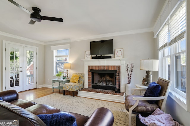 235 Chicopee Dr NE, Marietta, GA 30060 - living room featuring french doors, wood finished floors, a ceiling fan, crown molding, and a brick fireplace