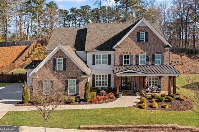 view of front of home with a front lawn, fence, brick siding, and concrete driveway