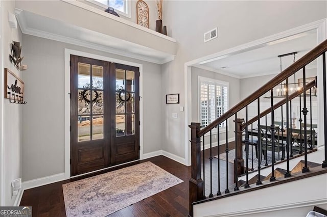 entryway with crown molding, stairway, french doors, dark wood-type flooring, and visible vents