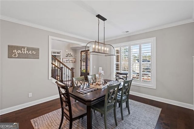 dining area featuring wood finished floors, ornamental molding, baseboards, and visible vents