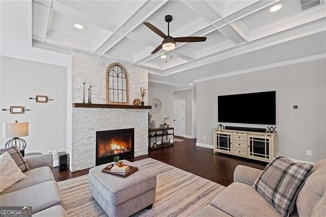 living area with coffered ceiling, beam ceiling, a fireplace, wood finished floors, and ceiling fan