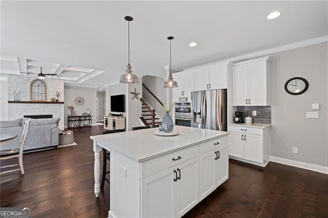 kitchen with coffered ceiling, light countertops, backsplash, stainless steel appliances, and dark wood-type flooring